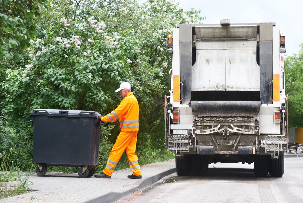 garbage collector truck loading wastes