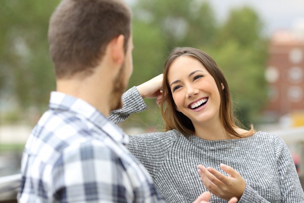 woman happily talking with a man