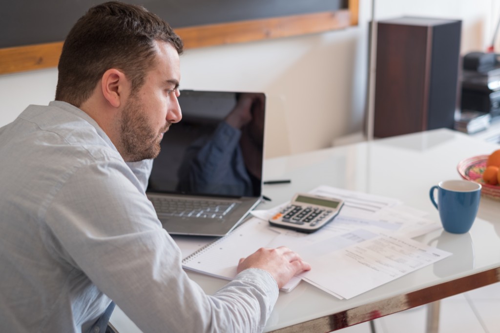 man computing his debts