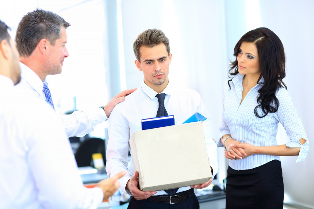 man leaving the office with his things