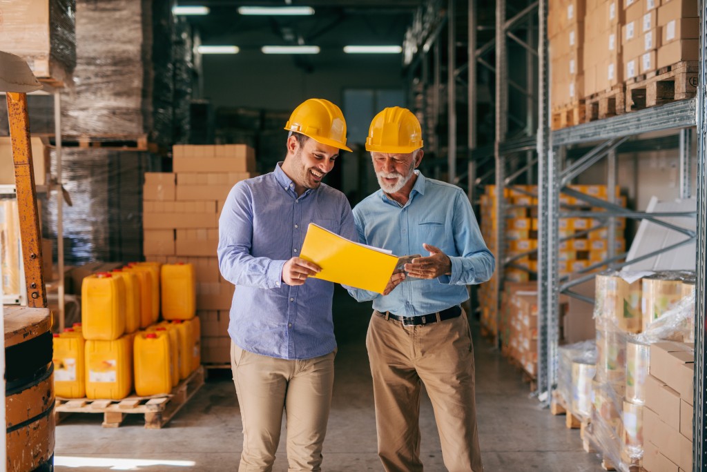 employees looking at file inside the warehouse