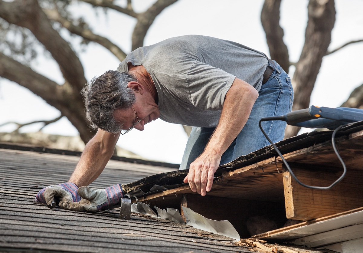 man fixing the roof