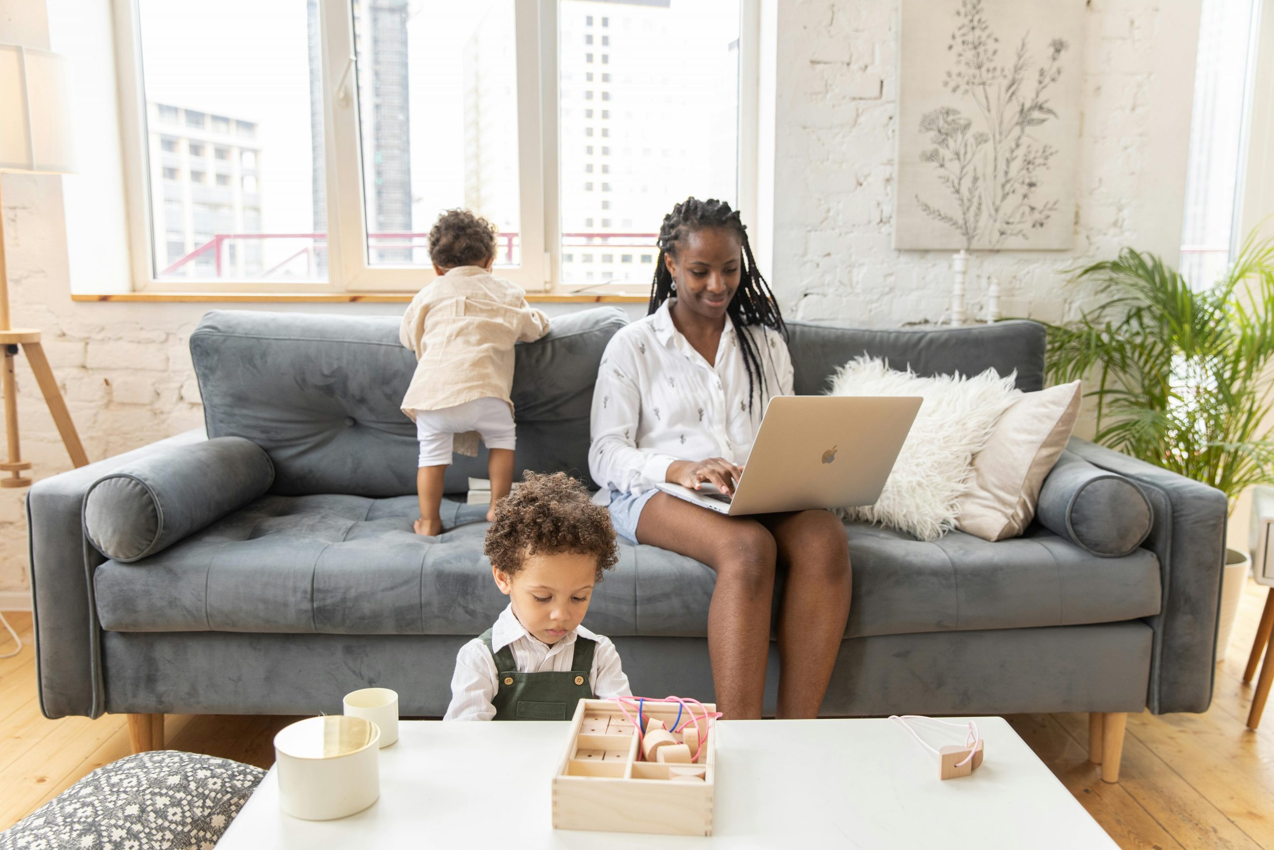 mother working remotely while her sons are playing