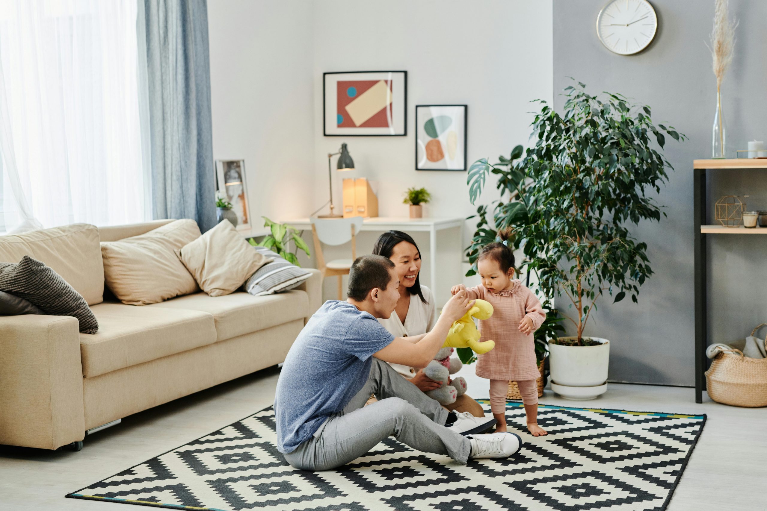 parents playing with their child in the living room